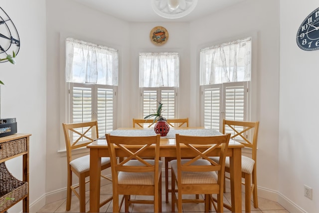 dining space featuring light tile patterned flooring