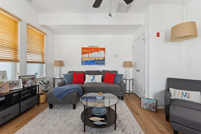 living room featuring light hardwood / wood-style flooring and ceiling fan