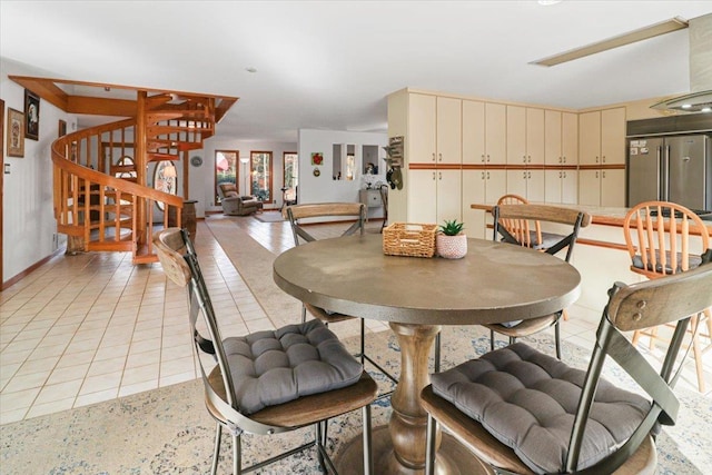 dining room with light tile patterned floors and stairway