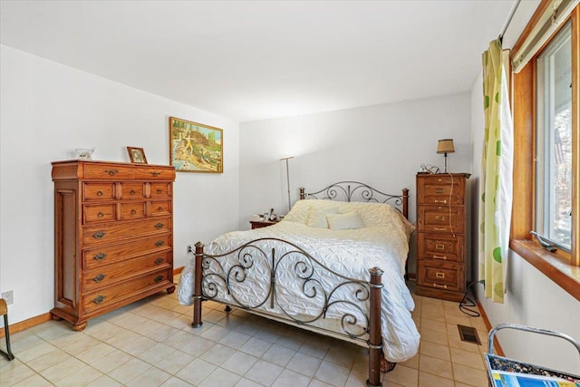 bedroom with light tile patterned floors, visible vents, and baseboards