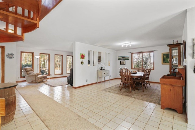 dining space featuring light tile patterned floors and baseboards