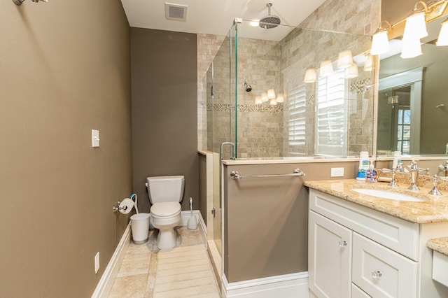 bathroom with visible vents, toilet, a stall shower, vanity, and baseboards