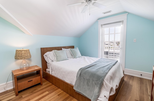 bedroom featuring visible vents, baseboards, and wood finished floors