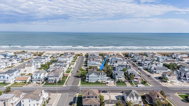 aerial view featuring a view of the beach, a residential view, and a water view