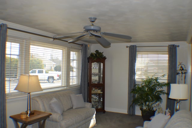 carpeted living area featuring a wealth of natural light, crown molding, and baseboards