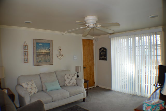 living room with baseboards, carpet flooring, a ceiling fan, and crown molding