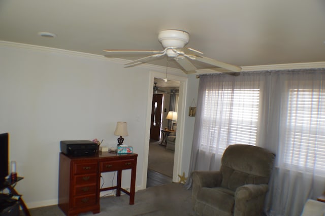 sitting room with ceiling fan, ornamental molding, and carpet flooring