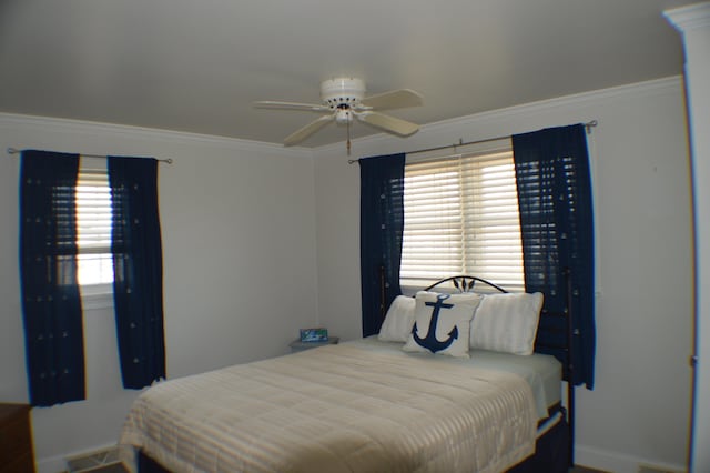 bedroom with a ceiling fan and crown molding