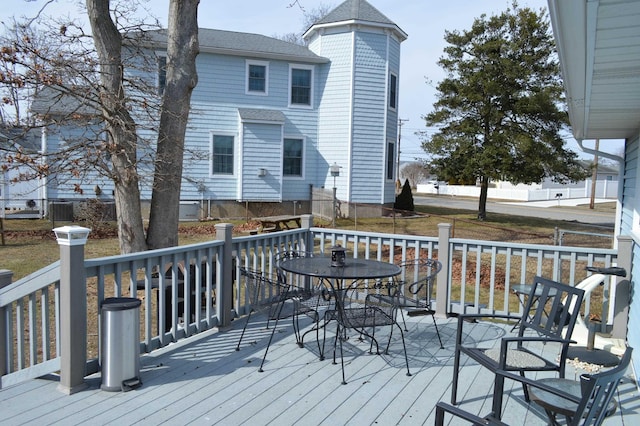 deck featuring outdoor dining area and cooling unit