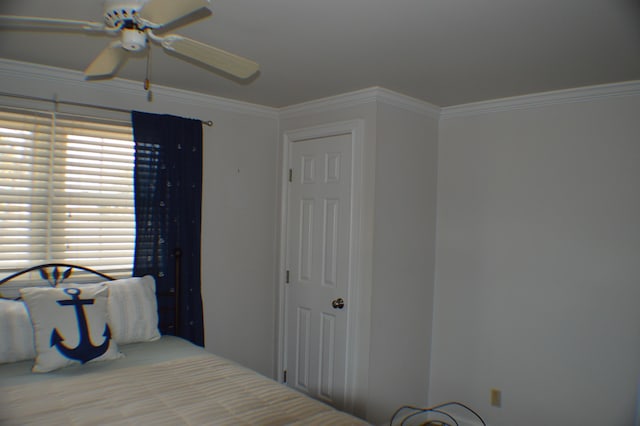 bedroom featuring ceiling fan and crown molding