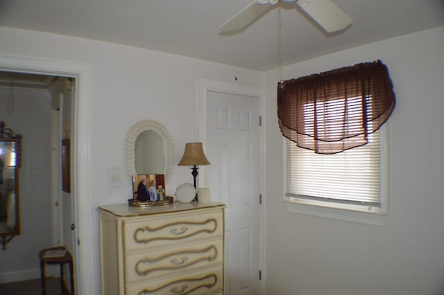 interior space with ceiling fan