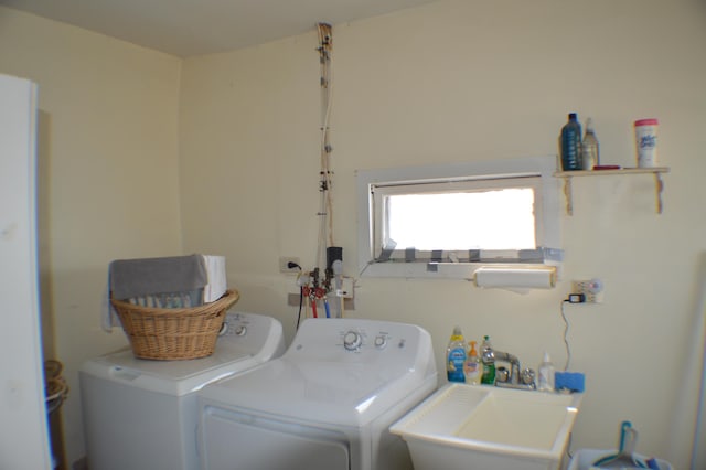 laundry room with a sink, laundry area, and washing machine and clothes dryer