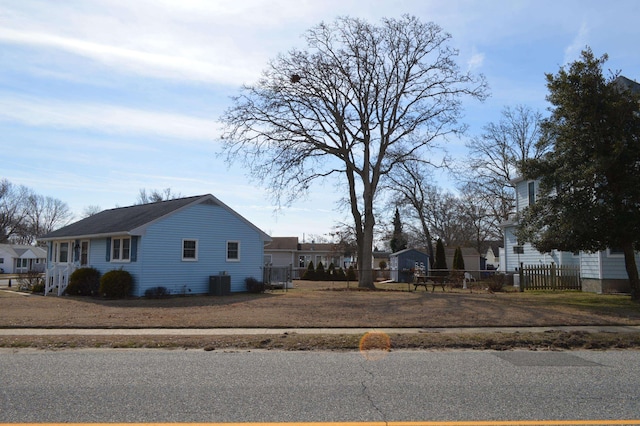 view of side of property with fence and a residential view