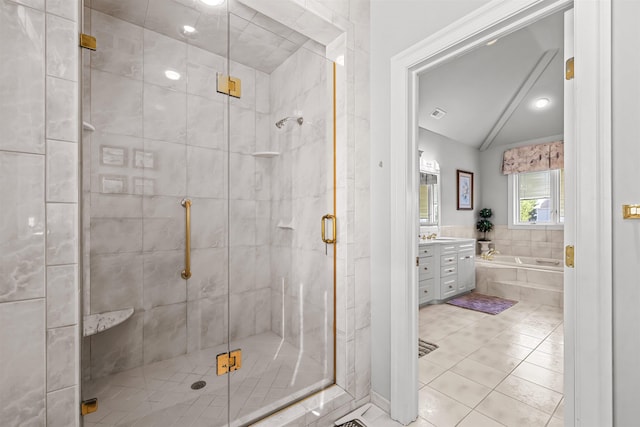 full bathroom featuring a shower stall, vanity, vaulted ceiling, tile patterned flooring, and a garden tub