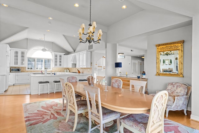 dining area featuring ceiling fan with notable chandelier, visible vents, vaulted ceiling, recessed lighting, and light wood finished floors