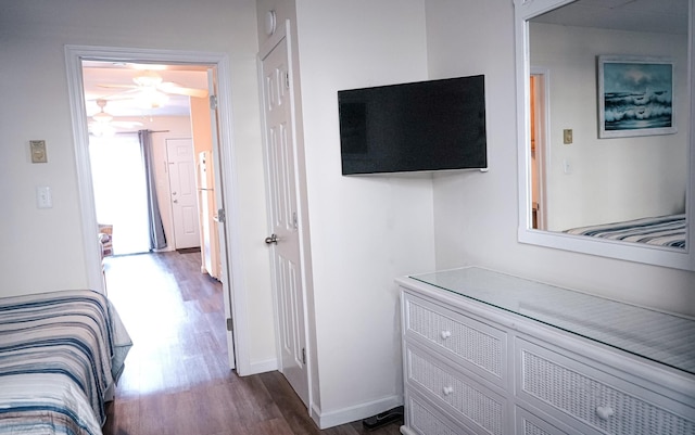 bedroom featuring dark wood finished floors and baseboards