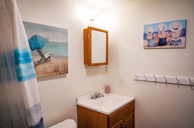 bathroom with toilet and vanity