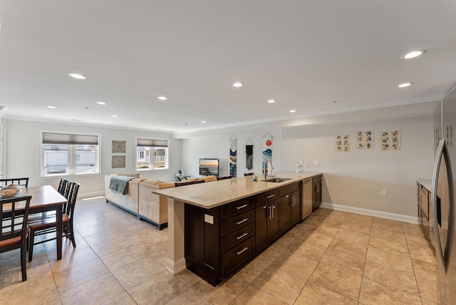 kitchen featuring kitchen peninsula, dark brown cabinets, crown molding, sink, and light tile patterned floors