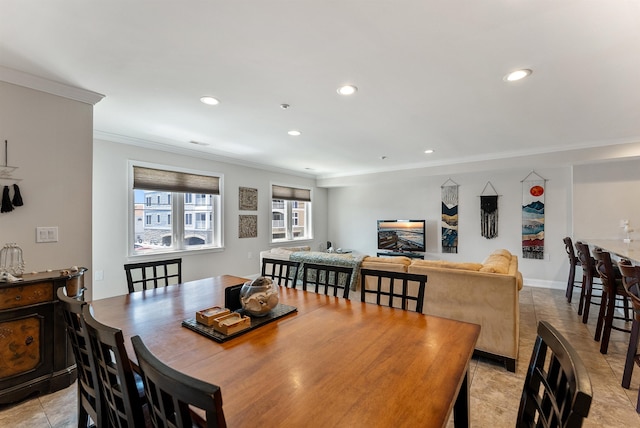 dining space with ornamental molding