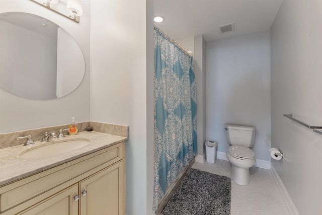 bathroom with tile patterned floors, vanity, and toilet