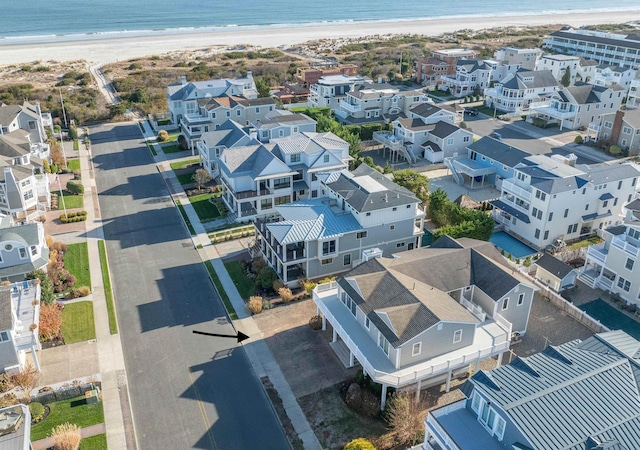 bird's eye view featuring a water view and a beach view