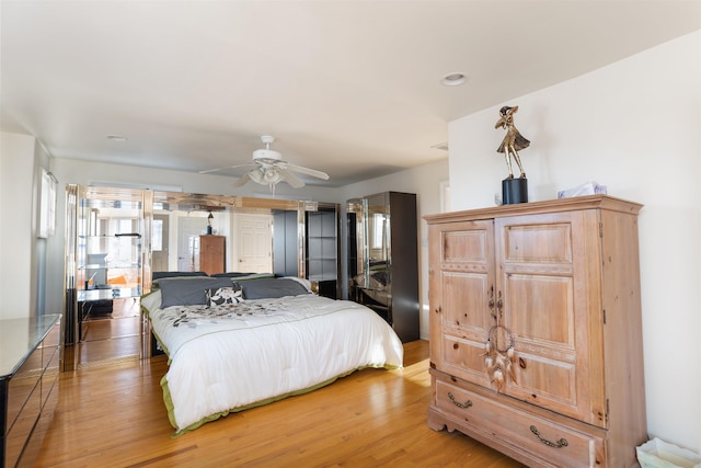 bedroom featuring hardwood / wood-style flooring and ceiling fan