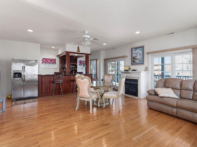 dining area featuring light hardwood / wood-style floors and ceiling fan