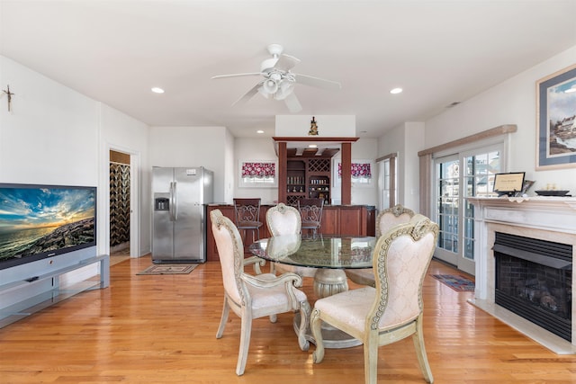 dining area with light hardwood / wood-style floors and ceiling fan