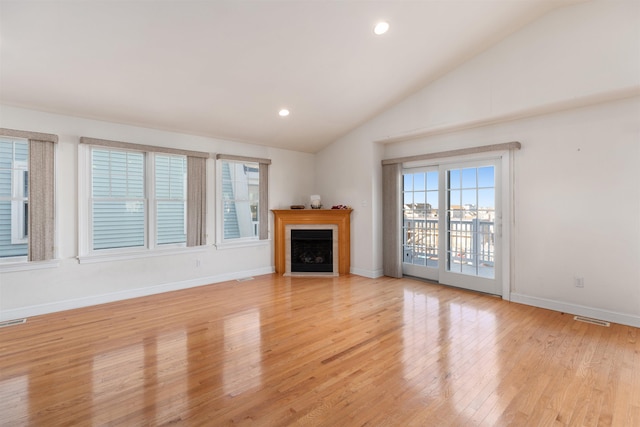 unfurnished living room with light wood-type flooring and lofted ceiling