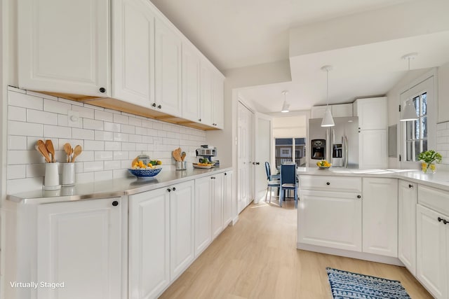 715 Eldredge Ave, North Cape May, NJ 08204 - kitchen with decorative backsplash, light countertops, white cabinetry, stainless steel fridge with ice dispenser, and light wood finished floors