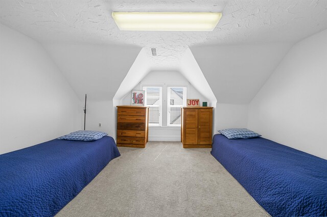 127 34th St, Avalon, NJ 08202 - bedroom featuring light carpet, lofted ceiling, and a textured ceiling