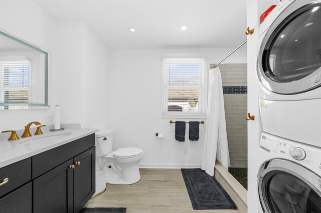 127 34th St, Avalon, NJ 08202 - full bath with stacked washer / dryer, vanity, toilet, wood finished floors, and a tile shower