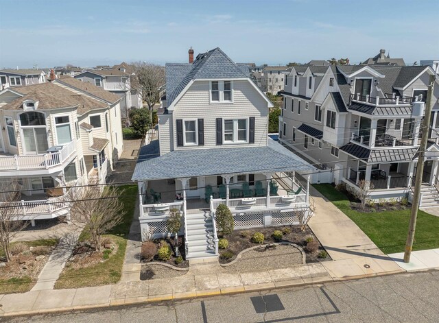 127 34th St, Avalon, NJ 08202 - view of front of property with a shingled roof, a porch, a residential view, stairway, and a chimney