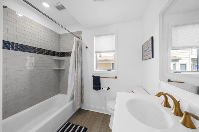 127 34th St, Avalon, NJ 08202 - full bathroom with toilet, shower / bath combo, plenty of natural light, and wood finished floors