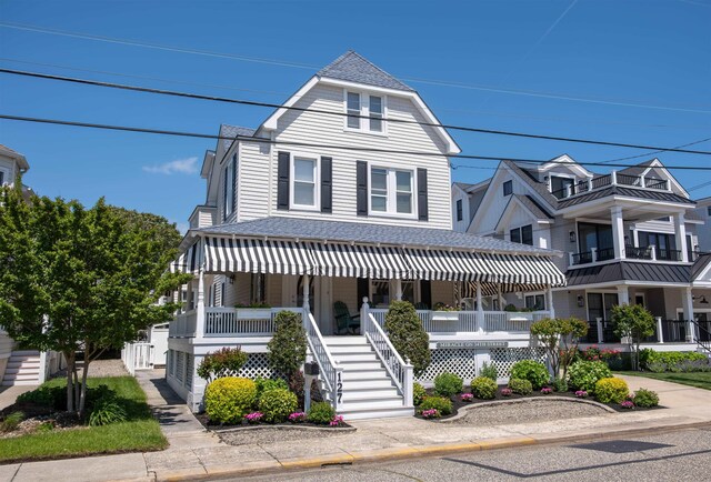 127 34th St, Avalon, NJ 08202 - view of front of property with a porch, roof with shingles, and stairway