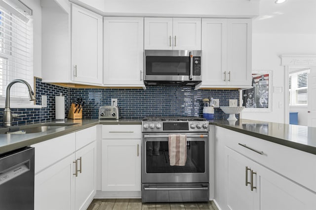 127 34th St, Avalon, NJ 08202 - kitchen featuring stainless steel appliances, a sink, tasteful backsplash, white cabinets, and recessed lighting