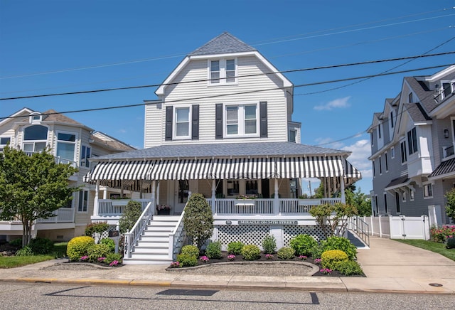 127 34th St, Avalon, NJ 08202 - view of front of home featuring a porch and a shingled roof