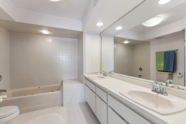 bathroom featuring tile patterned floors, vanity, a bath, and toilet