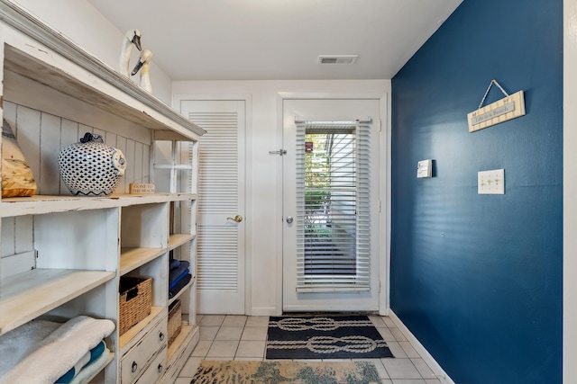 doorway with light tile patterned flooring