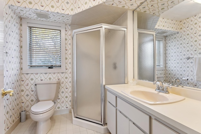 bathroom with tile patterned flooring, plenty of natural light, toilet, and a shower with door