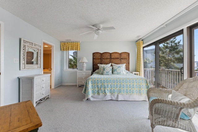 carpeted bedroom with ceiling fan, a textured ceiling, and access to outside