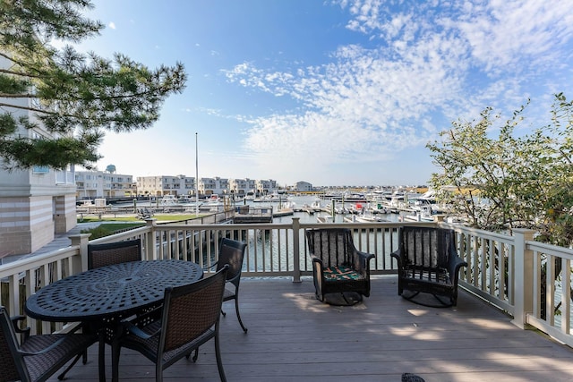 wooden terrace featuring a water view