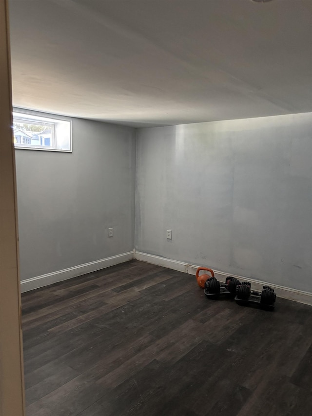 empty room featuring dark wood-type flooring and baseboards