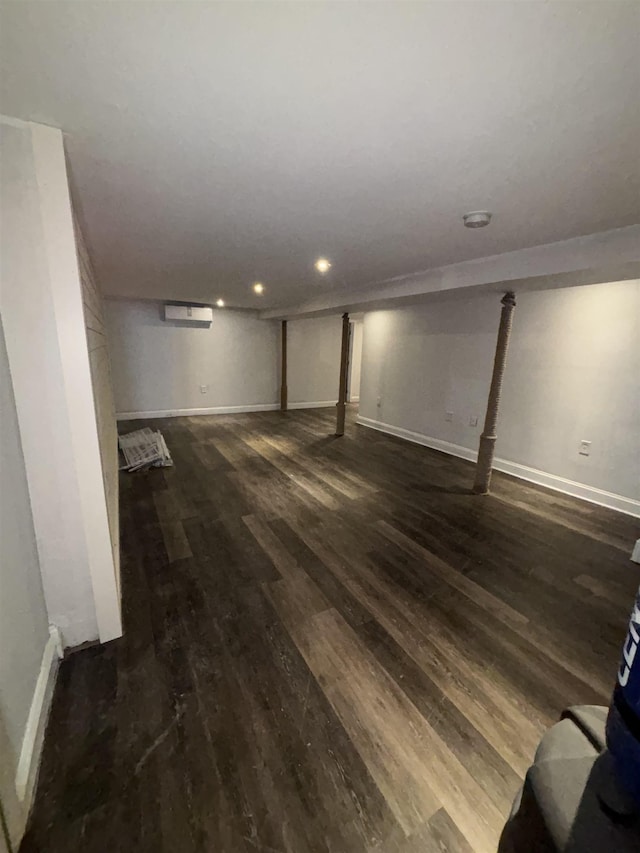 finished basement featuring dark wood-style flooring, recessed lighting, and baseboards