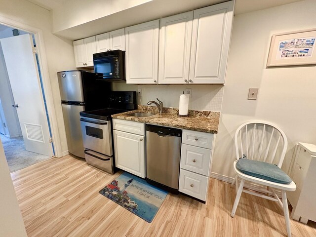 875 Plymouth Pl Unit 33, Ocean City, NJ 08226 - kitchen featuring appliances with stainless steel finishes, a sink, light wood-style flooring, and white cabinetry