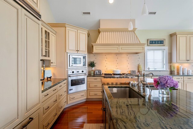 9 Seabreeze Ln, Avalon Manor, NJ 08202 - kitchen featuring cream cabinetry, appliances with stainless steel finishes, dark wood-type flooring, hanging light fixtures, and tasteful backsplash