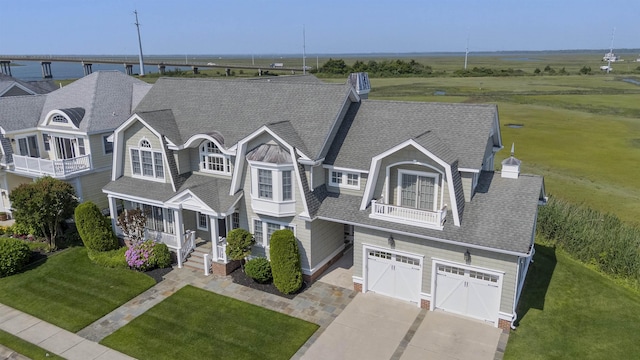 9 Seabreeze Ln, Avalon Manor, NJ 08202 - view of front of house featuring concrete driveway, an attached garage, roof with shingles, and a front yard