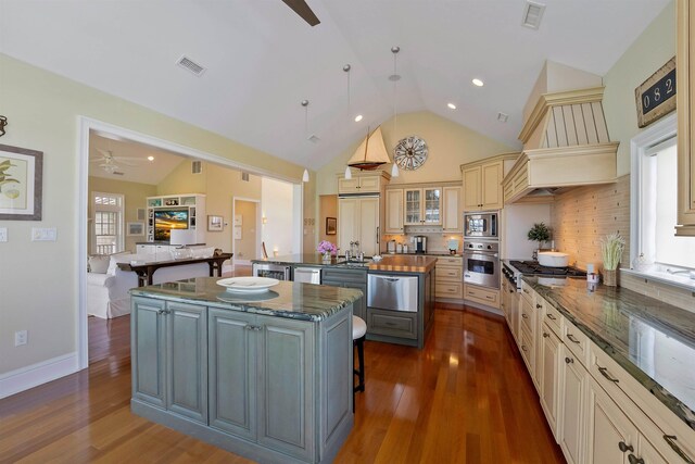 9 Seabreeze Ln, Avalon Manor, NJ 08202 - kitchen featuring a center island with sink, stainless steel appliances, a warming drawer, a kitchen bar, and ceiling fan