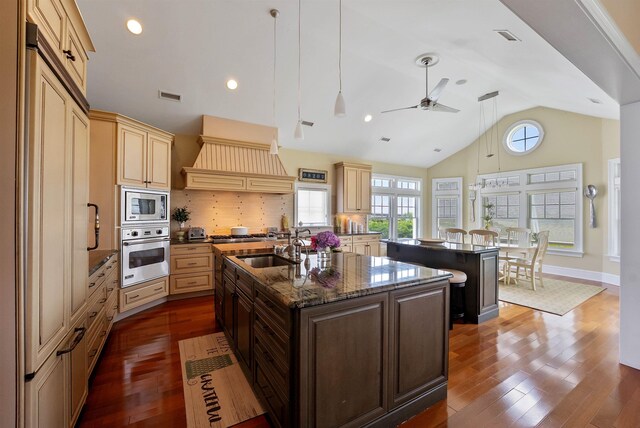 9 Seabreeze Ln, Avalon Manor, NJ 08202 - kitchen with stainless steel appliances, a kitchen island with sink, cream cabinetry, dark wood-type flooring, and ceiling fan