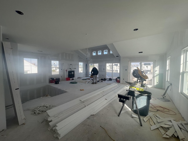 misc room with a healthy amount of sunlight and vaulted ceiling